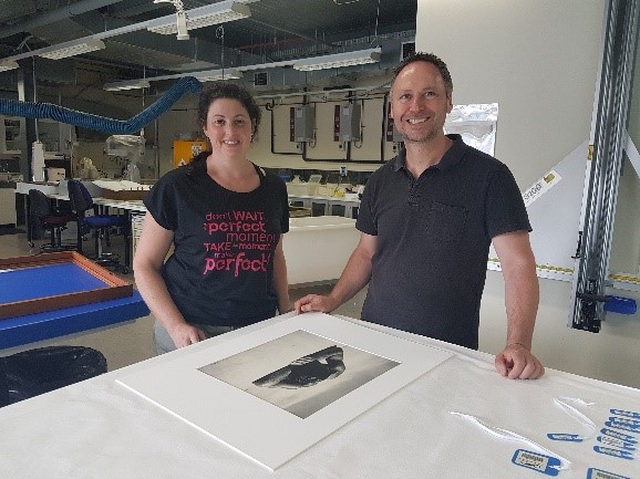 Amanda Edds and Jochen Letsch (ASA Framing) mounting images for Waves & Water. Image by N. Flood.
