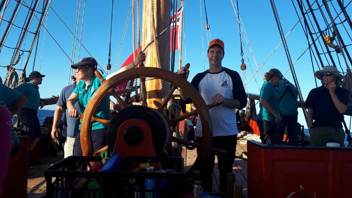 The birthday boy at the helm of the replica HMB Endeavour. Image: Agata Rostek-Robak.