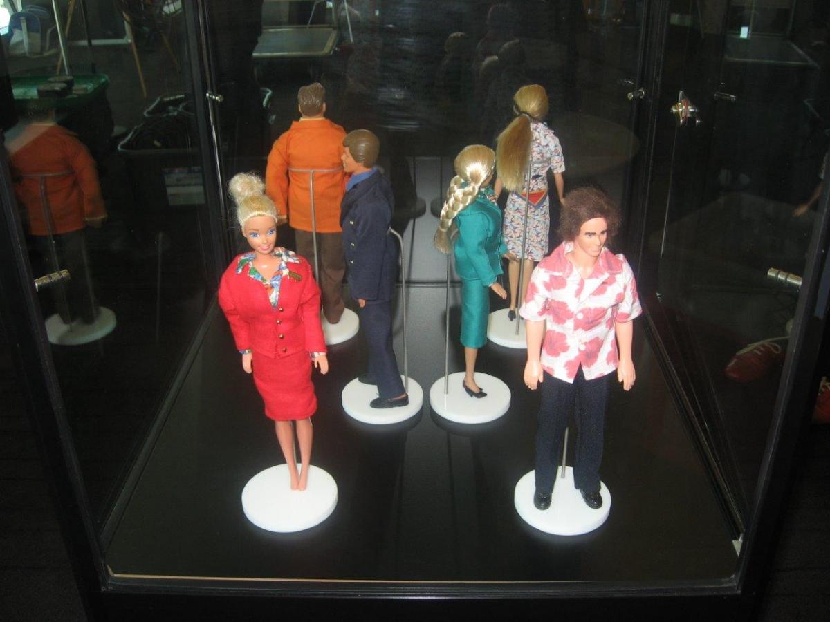 Some of the Barbie and Ken dolls dressed in miniature Qantas uniforms on display at the Sydney Qantas Club. Photo: F. Fitzpatrick