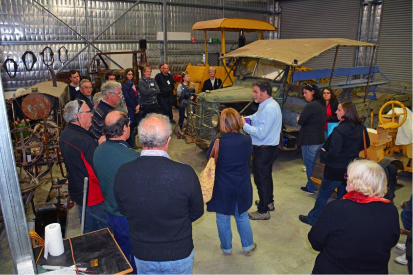 Participants discussing an unrestored shearing truck in the Revolutions Transport Museum store. Photo by Jon Carpenter