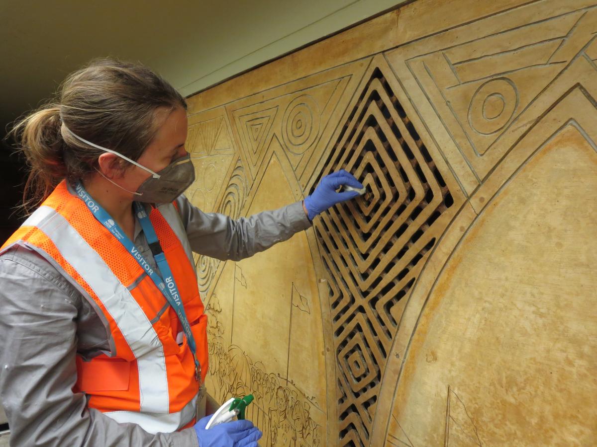 Cleaning and restoring the mural (Photograph of Conservator Katie Wood; photograph supplied by ICS, 2017)