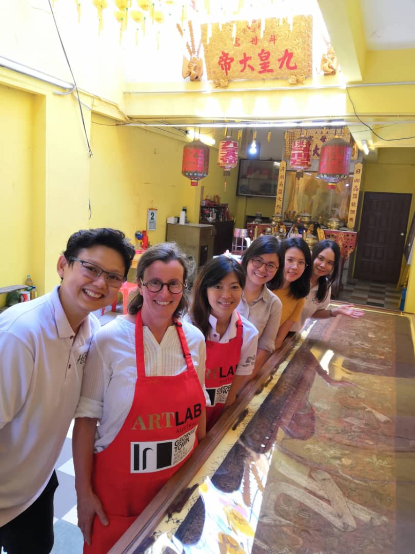 Image 1(left to right): Dr Ang, CEO Georgetown World Heritage Incorporated (GTWHI), Kristin Phillips, Principal Conservator Artlab Australia, Annie Lee, Conservator GTWHI, and volunteers Chuah Chi Ling, Ho Su San and Leaf Yeap Li Hua with the Nine Emperors Banner after treatment at the Tow Boh Keong Temple, Georgetown, Penang, Malaysia. Image: Artlab Australia.