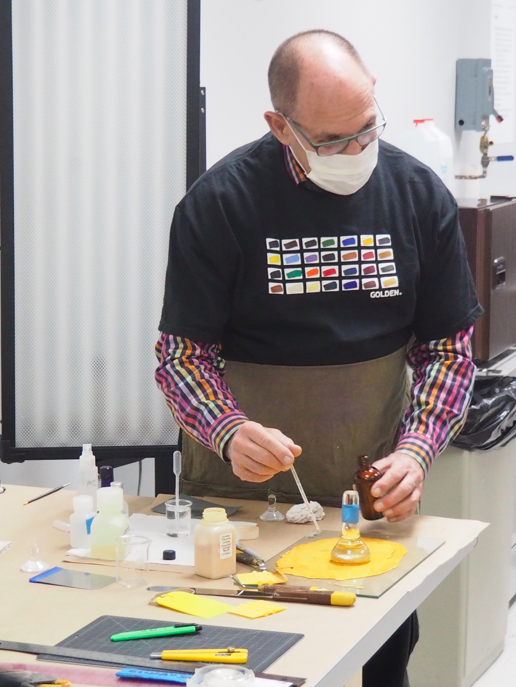 James Bernstein grinding titanium orange pigment. Image by Jodie Scott.