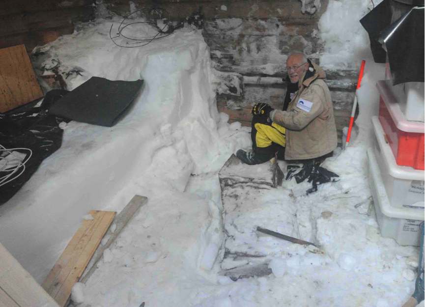 Peter Maxwell excavating snow and ice in the workshop (M.Berry 2015)