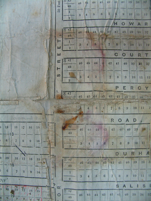 Red staining and weakened paper is all that remains of a mould colony on this printed map. Photo courtesy of the State Library of Victoria.