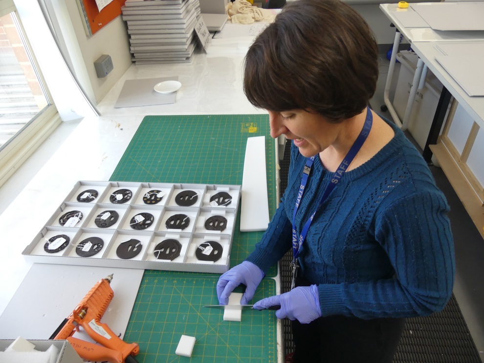Renita Ryan undertaking storage preparation for a collection of tsuba.