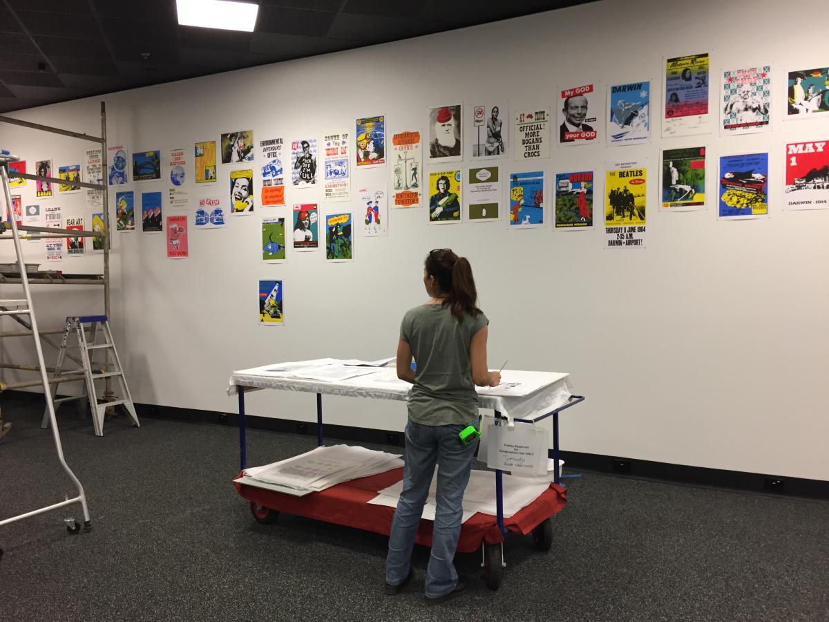 ‘S.Yee installing Franck Gohier poster wall’ photo by Wendy Wood