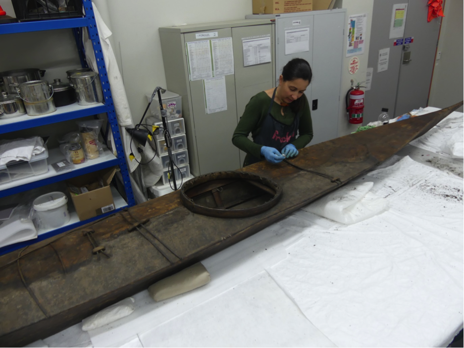 Object Conservator Sophie Parker working on an Inuit Kayak used by polar explorer John Rhymill.