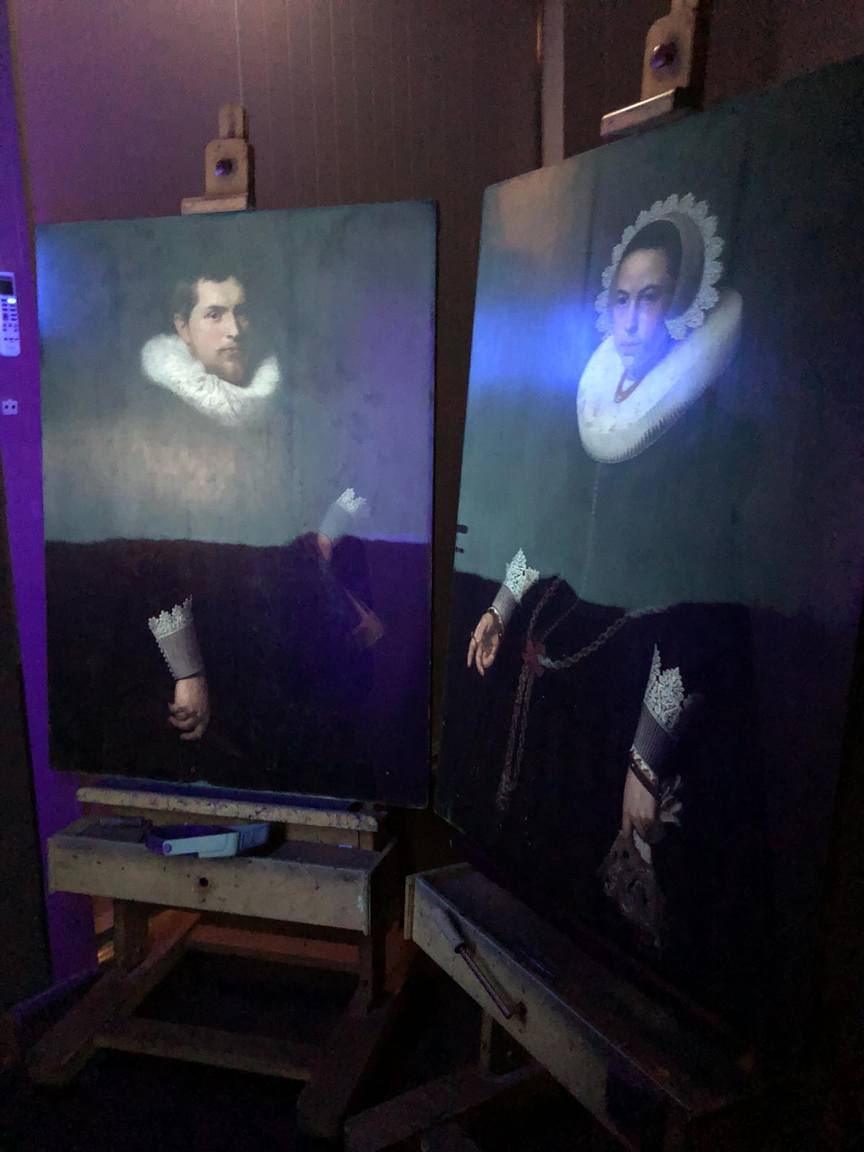Matching husband and wife Dutch panel portraits mid-way through varnish removal under ultra-violet light