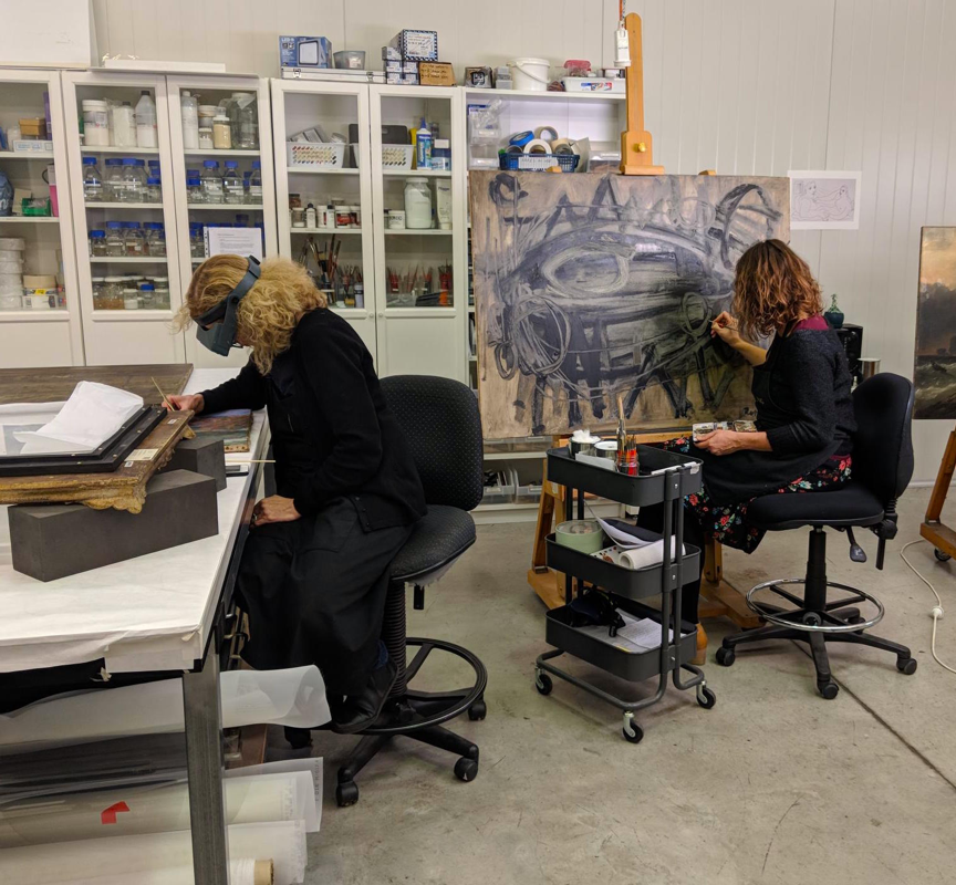 Julia Sharp and Anne Perrin in-painting in the studio