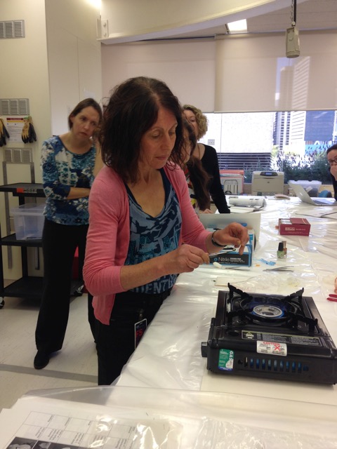 Yvonne Shashoua demonstrating the copper wire burn test to identify PVC at the Brisbane workshop held at the Queensland Museum (Anne Carter)