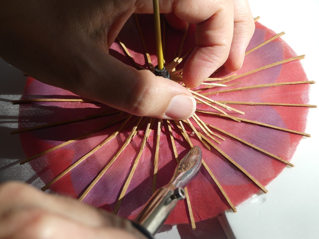 Attaching stretcher ribs to spokes with dyed Tyvek & Beva film. Image: Artlab Australia