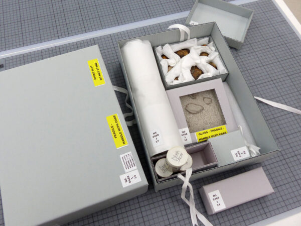 Custom-made boxes for Lake Pedder geological specimens, Pedder sand, ink stamp and time capsule.