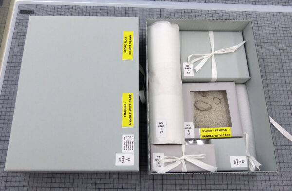 Images: Custom-made boxes for Lake Pedder geological specimens, Pedder sand, ink stamp and time capsule.