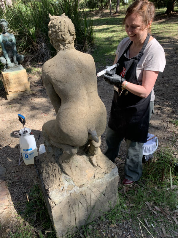 Wendy Reade conserving Norman Lindsay Squatting Satyr.