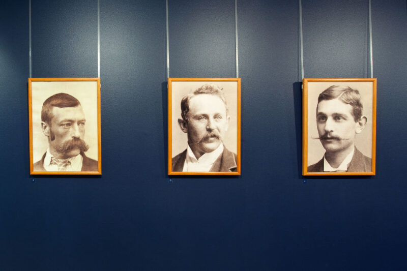three framed portrait photographs of men with moustaches