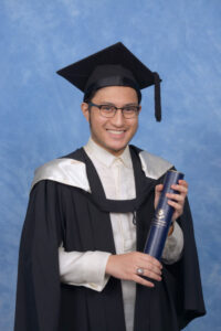 Young man holding University Parchment