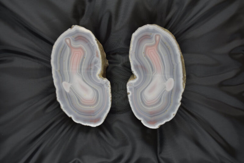 two agate mineral specimens on a black background