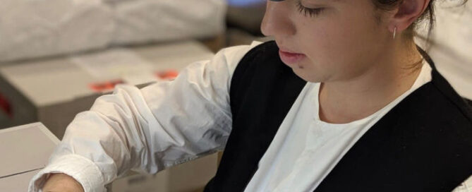 Young conservator working on a textile piece