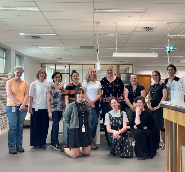The NLA Collection Care team in our new/old lab. From left to right (front to back) – Maria Genetzakis, Jacinta Sanders, Lucilla Ronai, Janet McDonald, Nicki Smith, Lisa Jeong-Reuss, Cheralyn Lim, Caroline Milne, Cheryl Jackson, Maren Innes, Adele Barbara, Aurelie Martin (not pictured: Tania Riviere, Nicole Rowney).