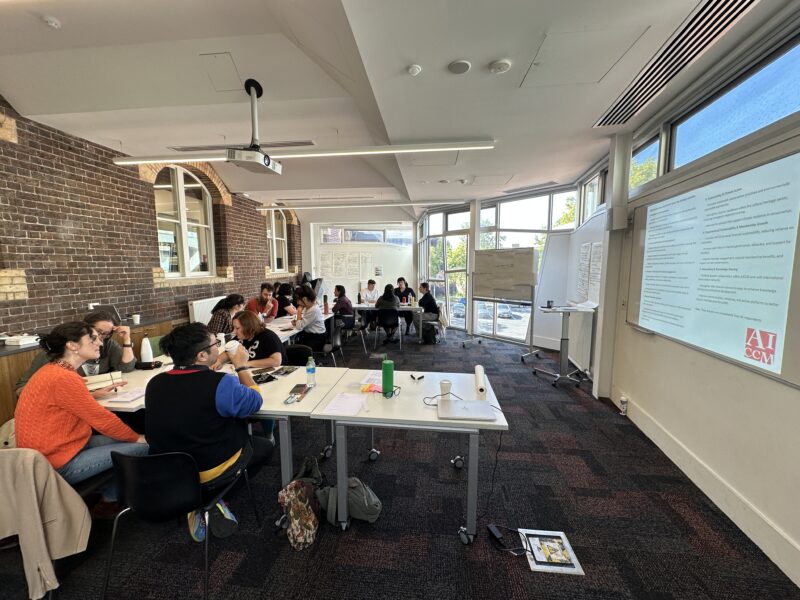 Group of people working in meeting room space at tables