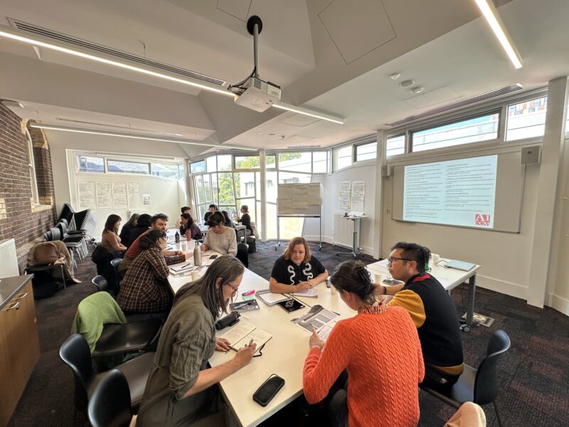 Group of people working in meeting room space at tables